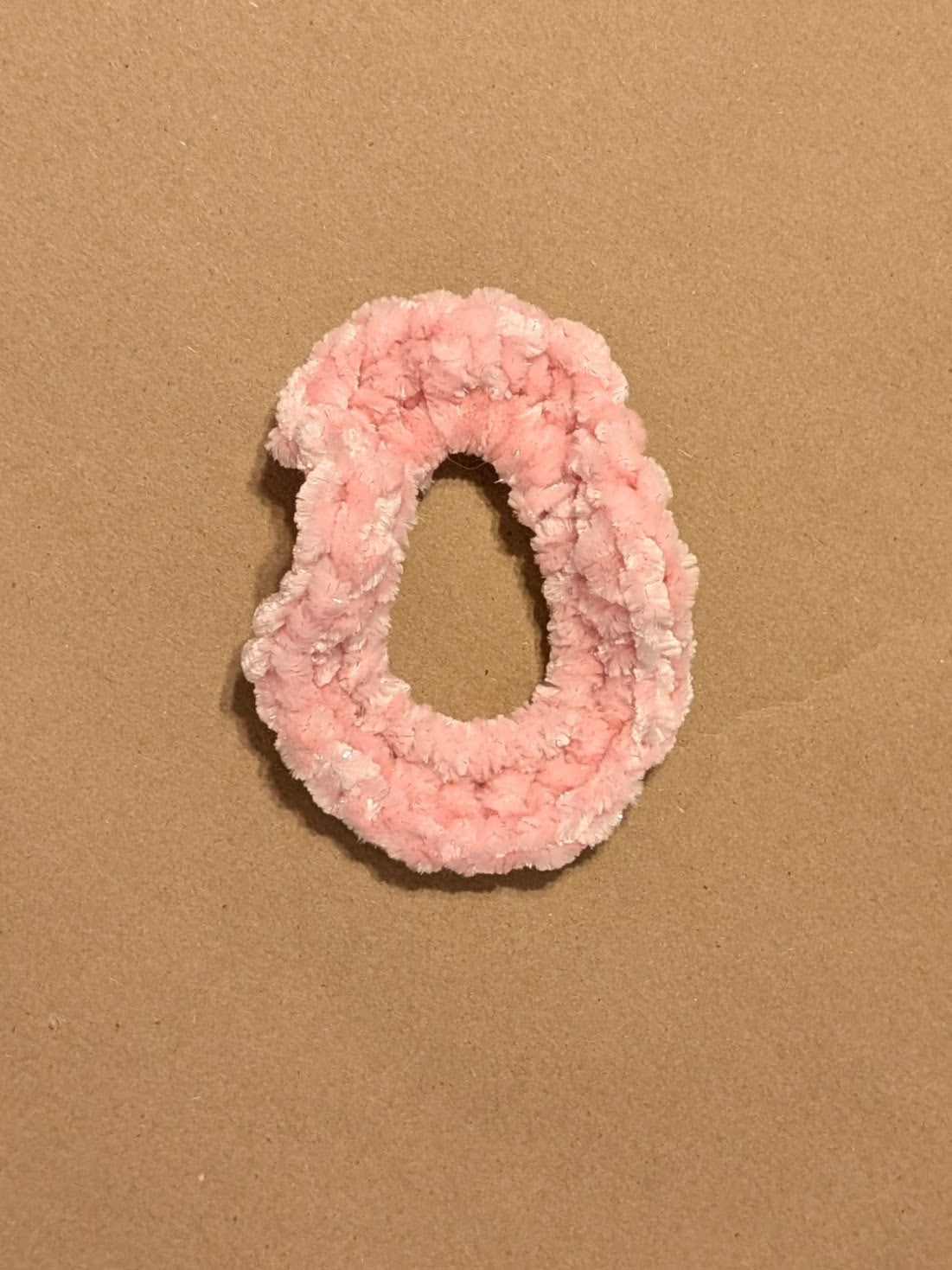 Pink scrunchie on a brown background