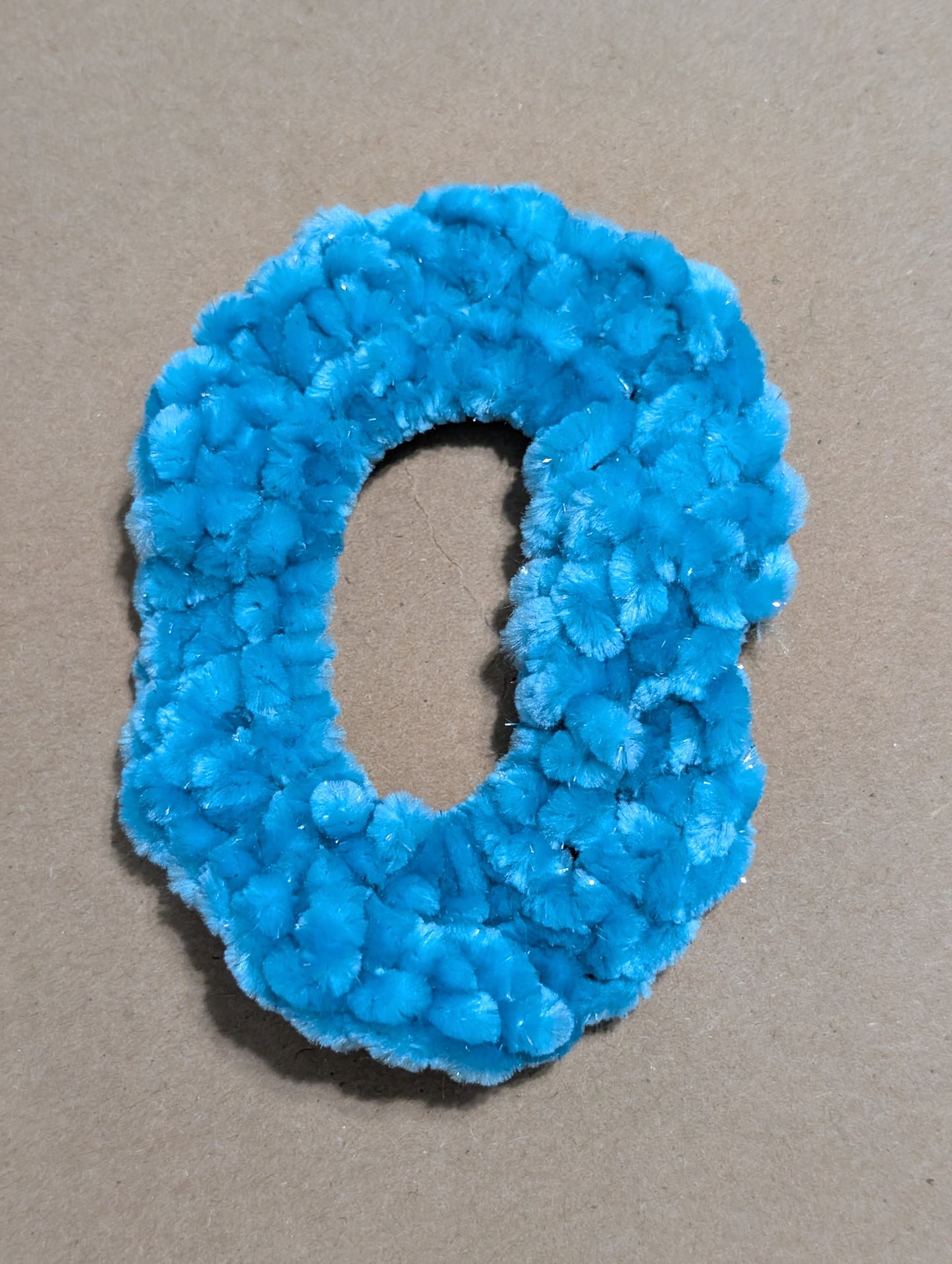 Blue scrunchie on a beige background