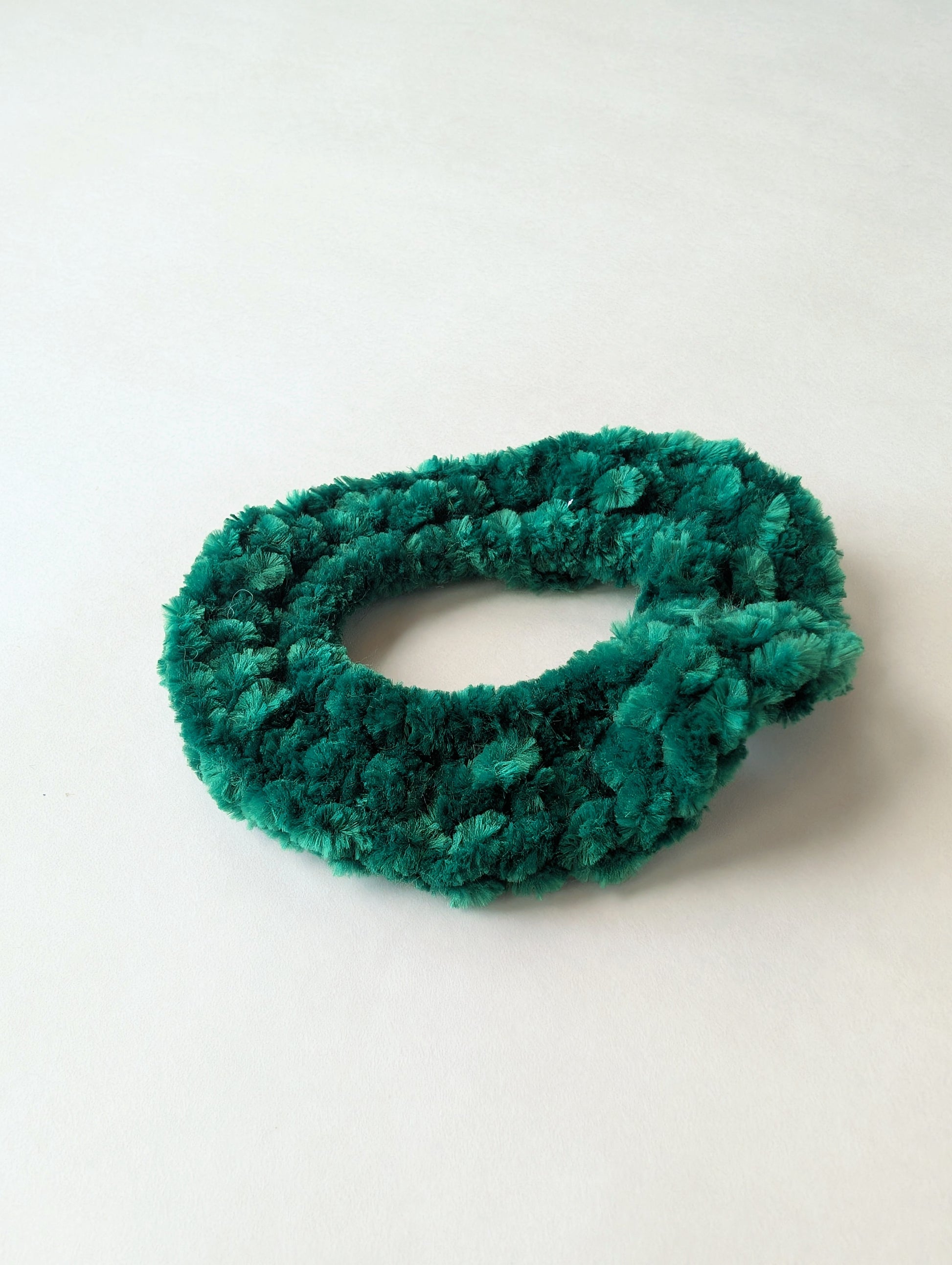 Green scrunchie on a white background