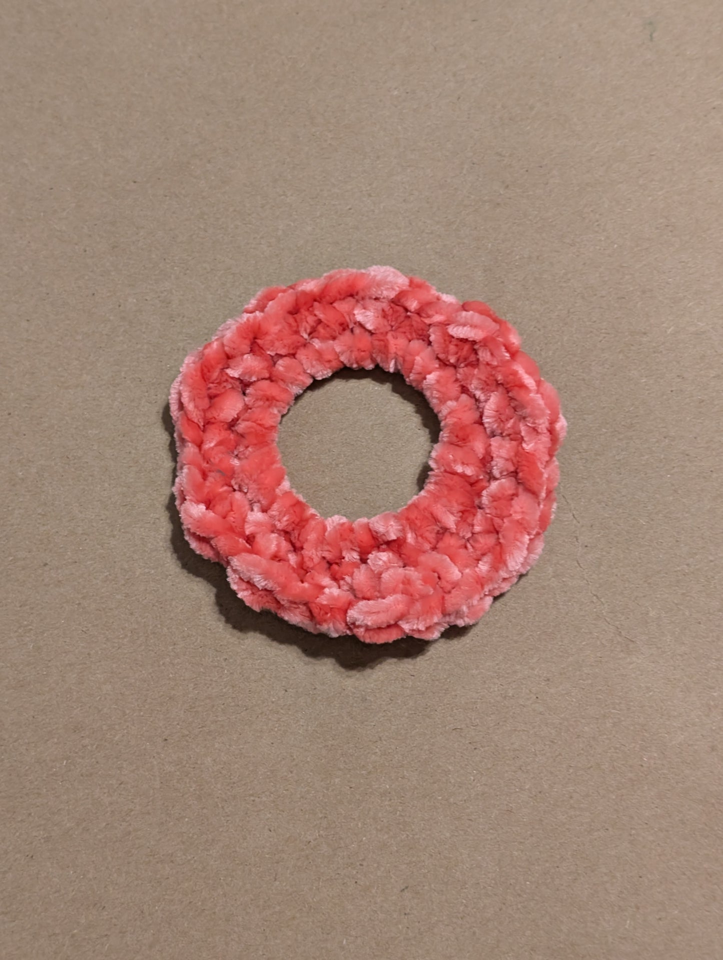 Pink scrunchie on a beige background