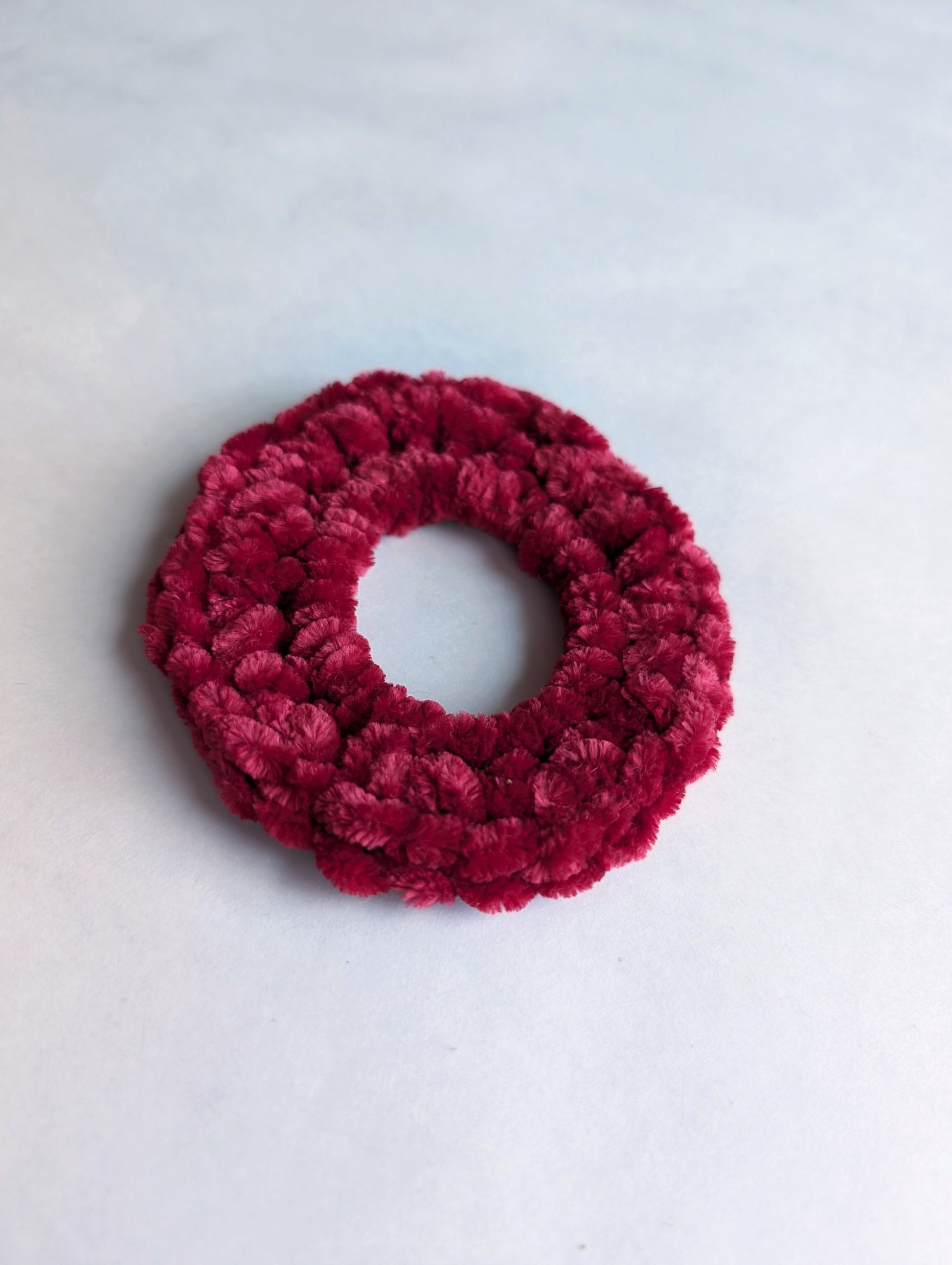 Red scrunchie on a white background