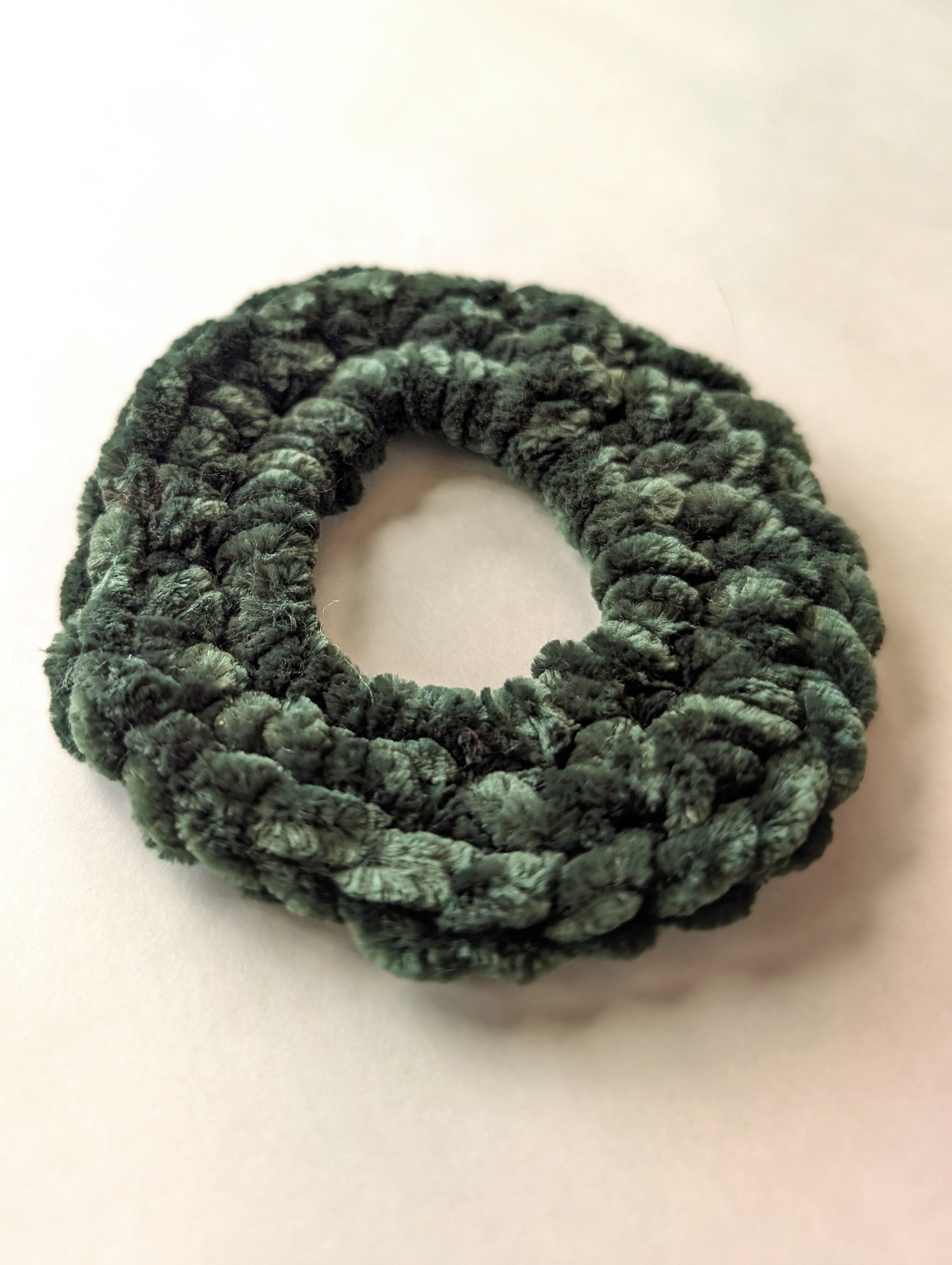 Green scrunchie on a white background